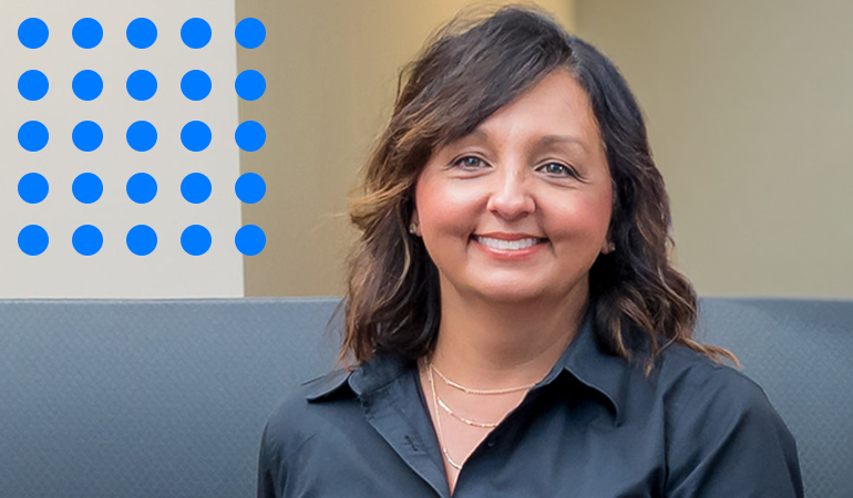 Forium Solutions, Lisa Coniker, smiling in an office environment