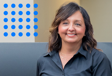 Forium Solutions, Lisa Coniker, smiling in an office environment
